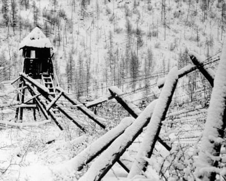 Barbed wire fence and guard tower at a disused Stalinist convict camp, Siberia, Russia, 1989.