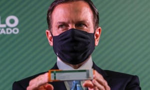 The governor of the Brazilian state of Sao Paulo, Joao Doria, holds a box of the Chinese vaccine against the Sinovac coronavirus during a press conference on its efficacy results at the Instituto Butantan in Sao Paulo, Brazil, on January 7, 2021.