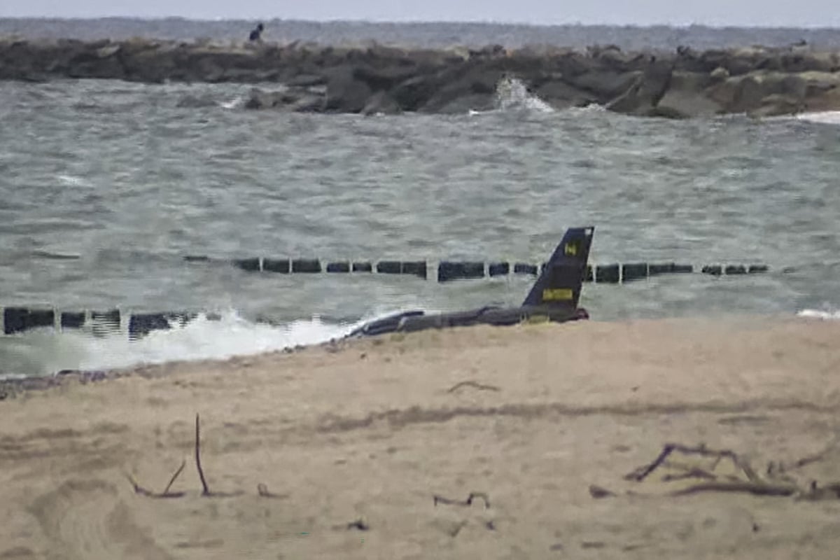 Wreckage of a suspected Russian drone lies in shallow water off a Baltic Sea beach