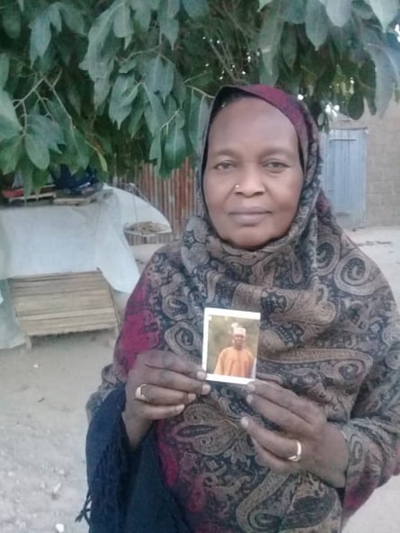 Hajja Gana Suleiman shows a photograph of her son