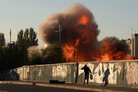 Passers-by fall to the ground following a drone attack in Kyiv.