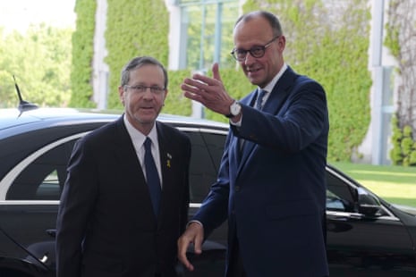 German Chancellor Friedrich Merz, right, welcomes Israeli President Isaac Herzog for a meeting at the chancellery in Berlin, Germany, Monday.