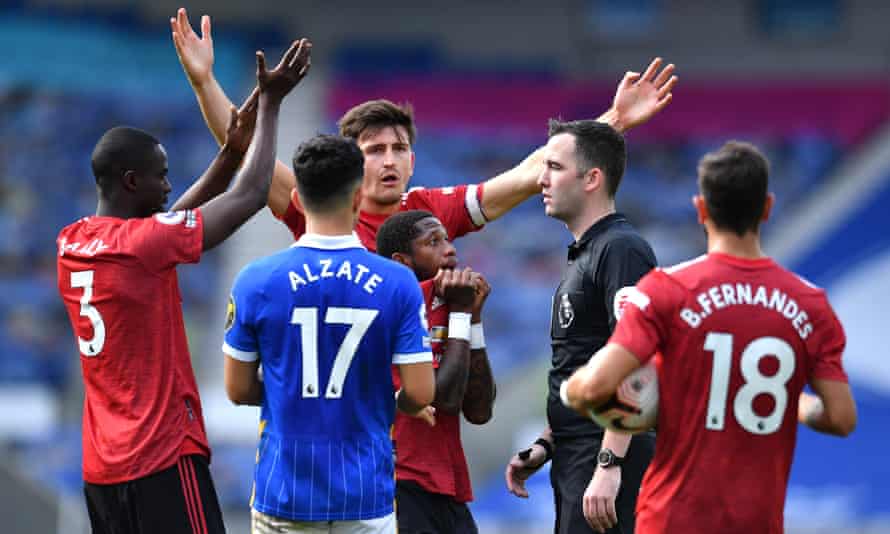 Harry Maguire leads the protests to referee Chris Kavanagh who blew the final whistle before checking his pitchside monitor and awarding Manchester United their match-winning penalty for a handball by Neal Maupay