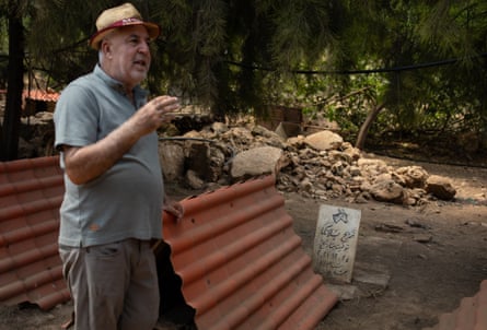 Hamze gestures near a gravestone with a drawing of a donkey