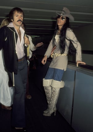 Raising the bar on airport style in her signature boots and a stetson at the airport in 1977