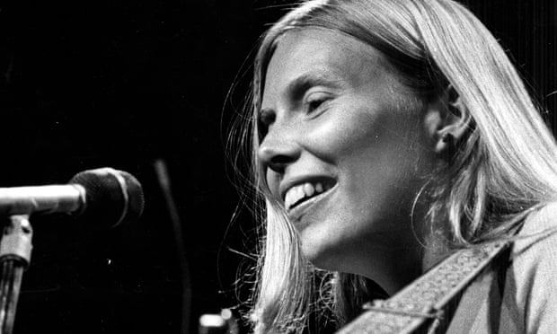 Joni Mitchell smiles in front of microphone