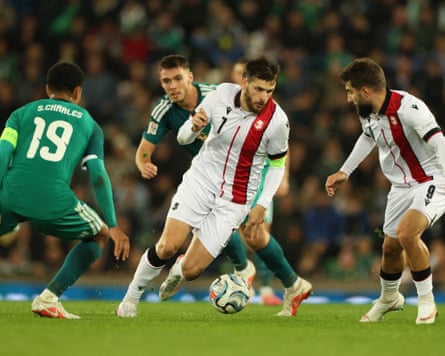 The Georgia captain, Khvicha Kvaratskhelia, takes on the Northern Ireland captain, Shea Charles, during their 0-0 Nations League draw in Belfast.