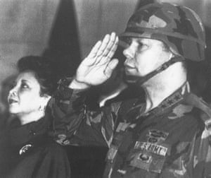 Lt Gen Colin Powell, commander of the 5th US corps, salutes while his wife Alma stands to attention during a farewell ceremony in Frankfurt in 1986