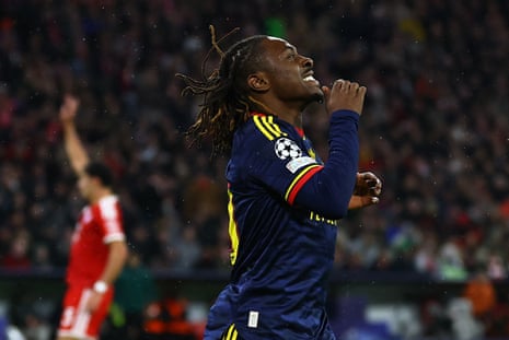 Arsenal's Eberechi Eze celebrates after scoring, arms raised and looking up