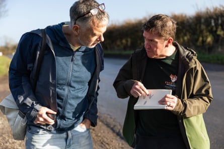 Wildlife tracker Darren Parkin shows Sam a diagram of a wallaby foot print.