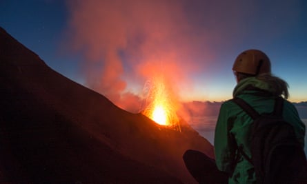 Young woman watching volcanos’ eruption at Stromboli
