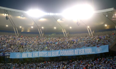 The Manchester City fans unveil a banner saying 'we're the boys in blue, we're coming after you'