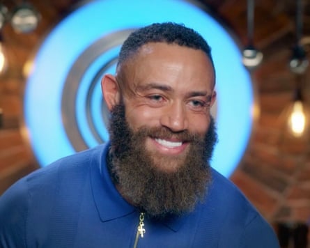 Cain smiles on screen in front of the MasterChef logo