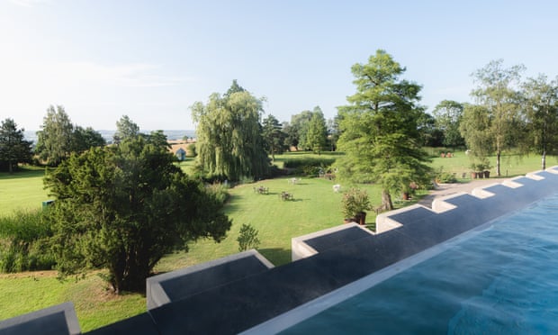 A rooftop pool with views over trees in a park estate