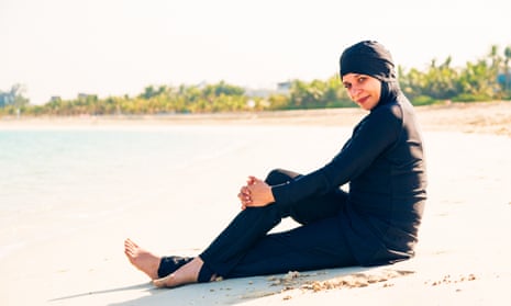 A woman wearing a burkini on the beach