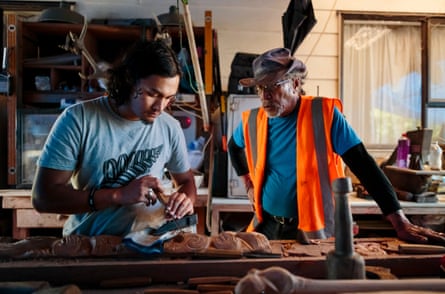 Kauri (Tekaurinui Robert) Parata, watched by his father Hori Parata, carves a traditional Maōri design at their home in Whangārei. Kauri is a member of the Manu Taupunga group that is the organising arm of the whale-body recovery operation started by his father, Hori Parata