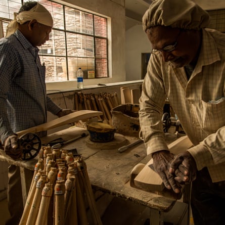 At the Sanspareils Greenlands factory in Meerut, Uttar Pradesh, workers polish cricket bats with sand paper, the last finish in the manufacturing process.