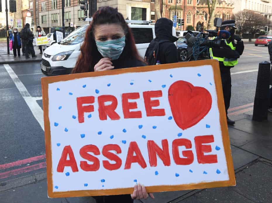 A supporter of Wikileaks founder Julian Assange holds a banner in central London, 6 January 2021. 
