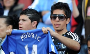 A Chelsea fan holds a shirt with Luka Modric’s name on the back during the summer of 2011, when the player was pushing for a move to Stamford Bridge