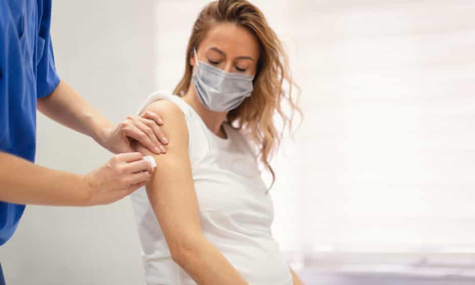 A pregnant woman being vaccinated