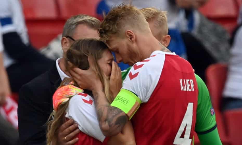 Simon Kjær consoles Christian Eriksen’s wife, Sabrina Kvist, after the Internazionale player collapsed on the pitch during the game against Finland.