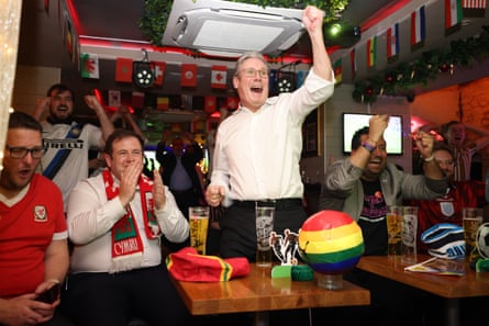 Labour party leader Sir Keir Starmer celebrates an England goal as he watches the FIFA World Cup match between Wales and England at New Bloomsbury Set cocktail bar in London on 29 November