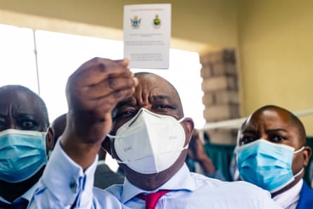 Zimbabwe vice president and minister of health Constantino Chiwenga holds up his vaccination certificate after receiving his first shot of Sinopharm, 18 February 2021