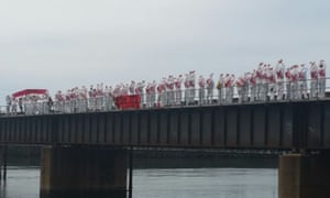 Protesters dressed in white overalls block the coal line that connects the coal mines in the Hunter Valley with the port at Sandgate in Newcastle, May 8, 2016.