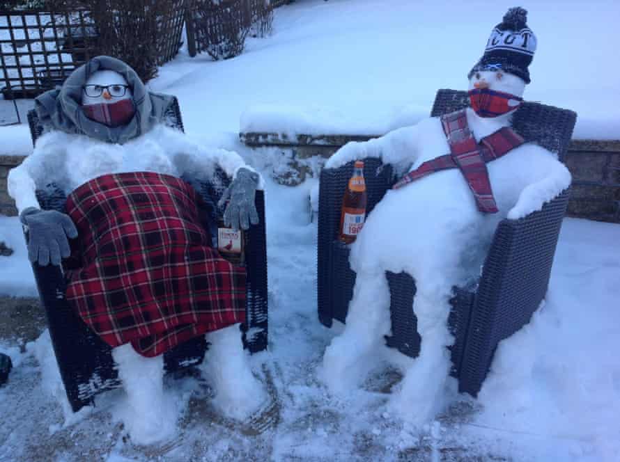 Two snowmen sitting in chairs