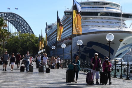 Cruise ship passengers disembark from the Princess Cruises owned Ruby Princess at Circular Quay in Sydney, Thursday, March 19, 2020.