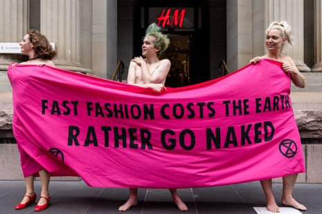 Activists wrapped with a banner stage a demonstration along Elizabeth Street in Melbourne on Friday.