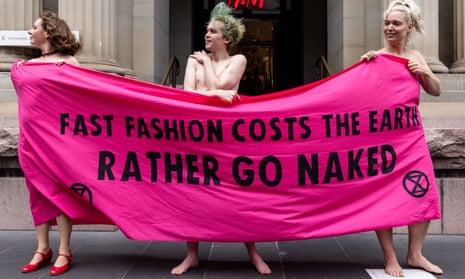 Activists wrapped with a banner stage a demonstration along Elizabeth Street during an Extinction Rebellion protest in Melbourne