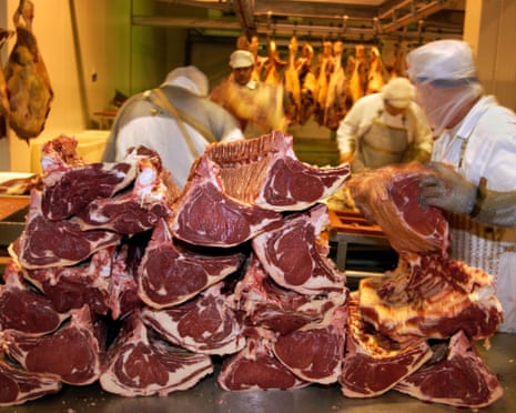 Beef carcasses being processed at a factory