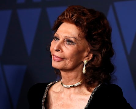 Sophia Loren wearing a black dress stares away from the camera