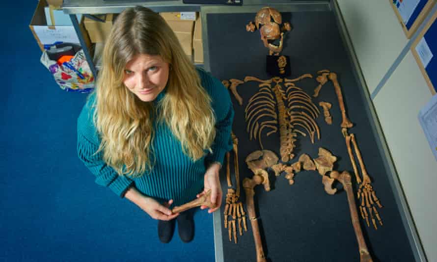 Annsofie Witkin with the skeleton of a young woman, shot from above