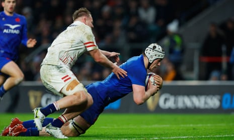 Thibaud Flament of France scores their side’s fourth try whilst under pressure from Alex Dombrandt of England.
