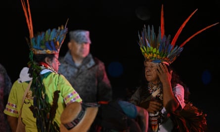 Indigenous people and a member of the military during the search.