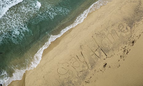 An aerial view of Bronte Beach with the words #StayHome written into the sand by local lifeguards on Thursday after the Australian government introduced further restrictions on movement and gatherings in response to the ongoing COVID-19 pandemic.