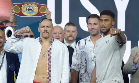 Oleksandr Usyk and Anthony Joshua pose for the cameras during the weigh-in for their heavyweight title fight in Jeddah