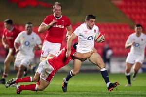 George Ford is tackled by Wales’ Leigh Halfpenny.