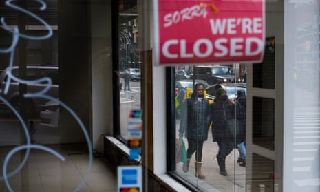 Pedestrians walk past a closed store in New York, New York on 8 January 2021. 