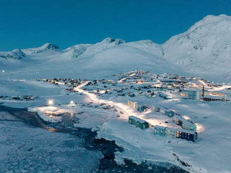 aerial photo of a small town in a snowy valley at dusk