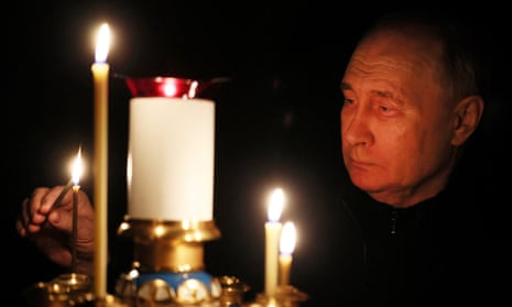 Vladimir Putin looking at candles