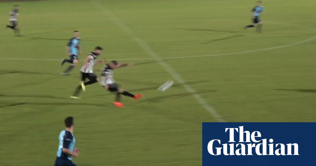 Non-league footballer scores spectacular goal from inside own half – video