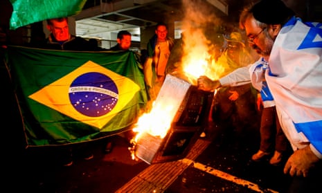 Supporters of Jair Bolsonaro set on fire to a model of an electronic voting device in Sao Paulo, Brazil on Sunday night.
