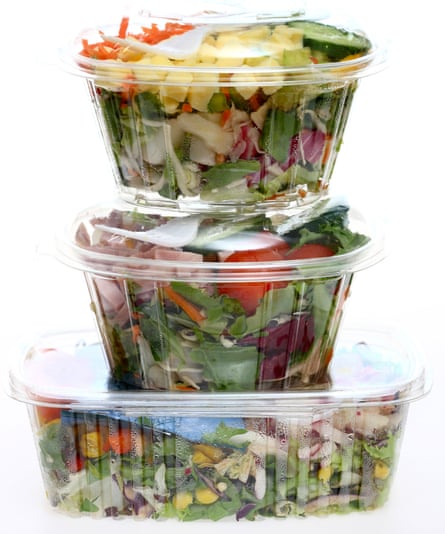 Packed, fresh prepared salads in a plastic box, from a cooler in a supermarket.
