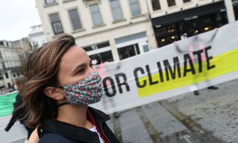 A woman takes part in a climate protest in Brussels