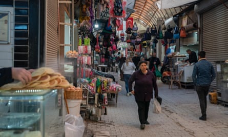 Residents shop in the partially damaged but still functioning covered market in downtown Antakya.