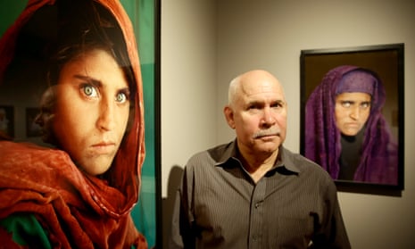 Photographer Steve McCurry with his photos of Sharbut Gula, the ‘Afghan Girl’ at the opening of his Overwhelmed by Life exhibition in 2013.