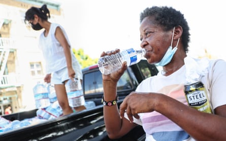 A woman drinks water during a heatwave in September 2022 in downtown Los Angeles, California.